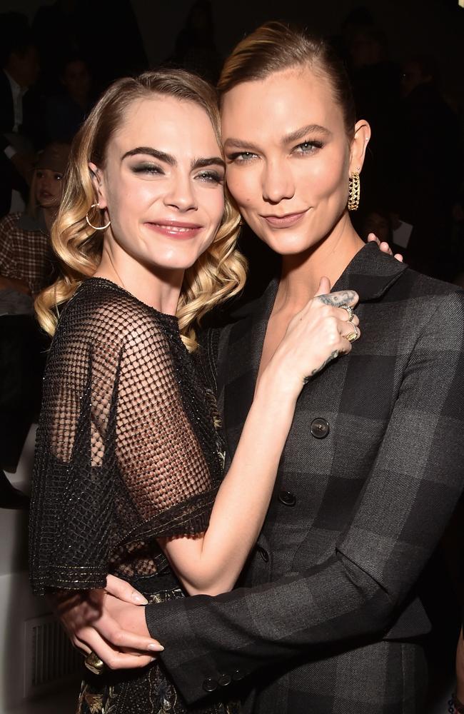 Cara Delevingne and Karlie Kloss have a cuddle at the Dior Fall/Winter 2020/2021 show. Picture: Stephane Cardinale/Corbis via Getty Images