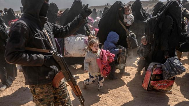 Women and children evacuated from the Islamic State holdout of Baghouz in Syria’s Deir Ezzor province arrive at a screening area supervised by the Kurdish-dominated, US-backed Syrian Democratic Forces. Picture: AFP 