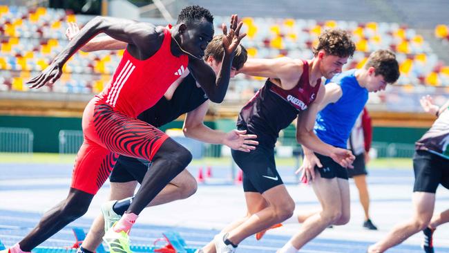 Australian sprinter Gout Gout (L) competes in the 100m heat.