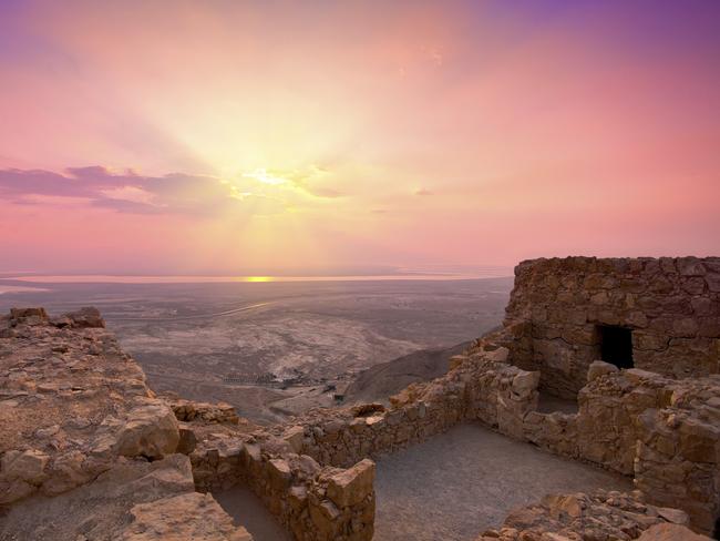 Beautiful sunrise over Masada fortress in Judaean Desert, Israel.