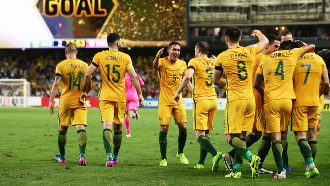 Mathew Leckie of the Socceroos celebrates with team mates.