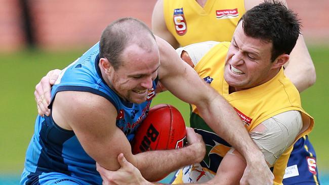 Sturt’s Luke Panozzo is tackled by Eagles ruckman Craig Parry.