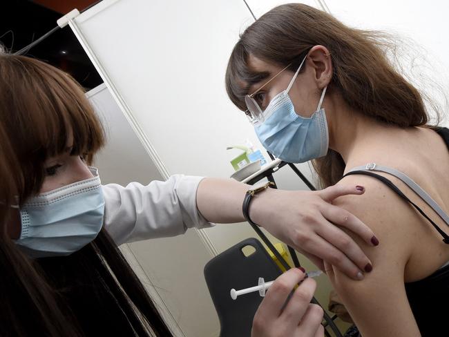 A patient receives the Pfizer/BioNTech vaccine in the hippodrome turned into a vaccination centre against the Covid-19, in Marcq-en-Baroeul, a Lille's suburb, northern France, on April 4, 2021. (Photo by FRANCOIS LO PRESTI / AFP)