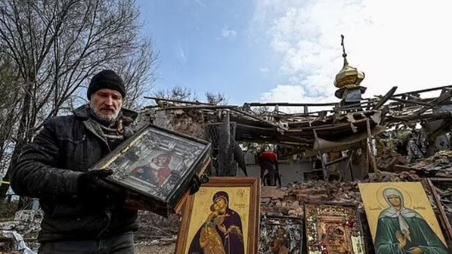 A man carries an Orthodox icon at the sacred site. Picture: Reuters