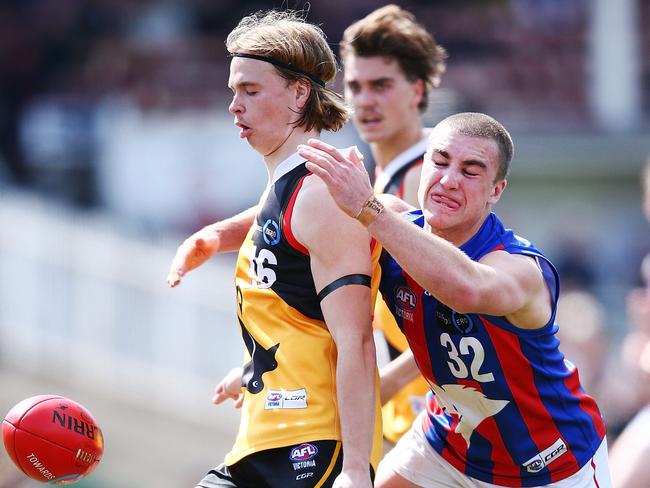 MELBOURNE, AUSTRALIA - SEPTEMBER 22:  Jake Frawley of the Dandenong Stingrays kicks the ball from Jack Ross of the Oakley Chargers during the 2018 TAC Cup Grand Final match between Dandenong and Oakleigh at Ikon Park on September 22, 2018 in Melbourne, Australia.  (Photo by Michael Dodge/AFL Media/Getty Images)