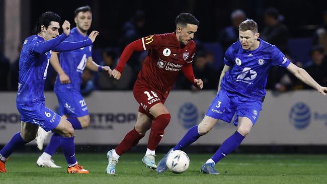 Adelaide United’s Zach Clough surrounded by Northcote City defenders. Picture: Daniel Pockett