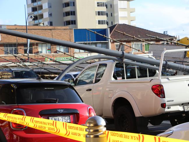 The driver of this white ute was lucky to escape unharmed with a street light pole falling onto the ute as it drove down Mann St. Picture: Fiona Killman