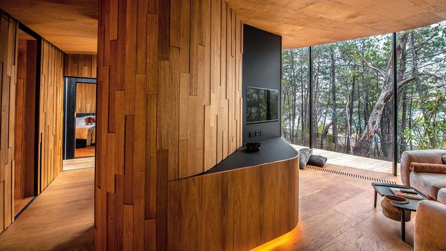 Curved timber walls cocoon and surprise guests on arrival – especially at night.