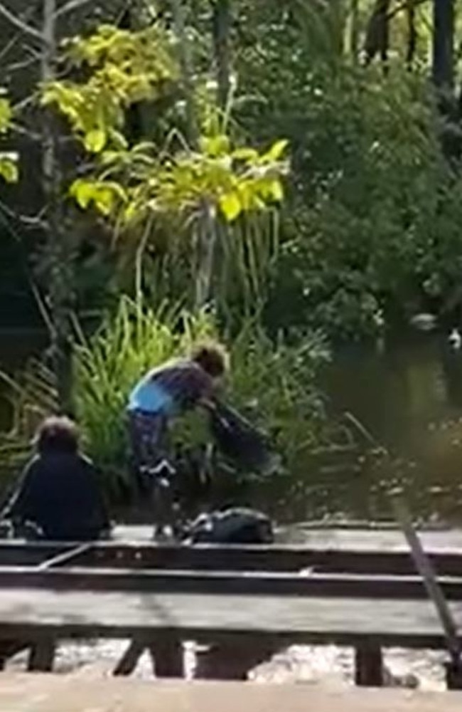 A video has surfaced showing a group of people dumping rubbish into the Howard River in the Northern Territory from the old Iron Bridge, sparking outrage.