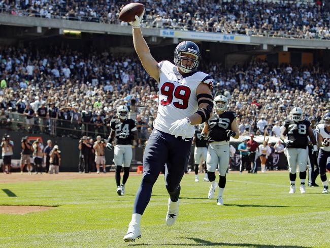 J.J. Watt #99 of the Houston Texans celebrates after scoring a touchdown against the Oakland Raiders.
