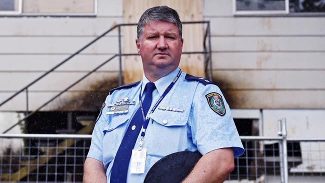 Superintendent Scott Tanner pictured in front of properties that still lay abandoned after 2022 floods in Lismore. Picture: Sam Ruttyn