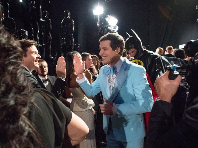 Andy Samberg high-fives fellow actor Jason Bateman backstage at the Oscars.