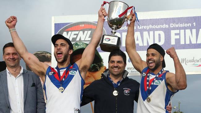 Nathan Valladares, Rob Maiorana and Ahmed Saad hoist the premiership cup. Picture: Hamish Blair