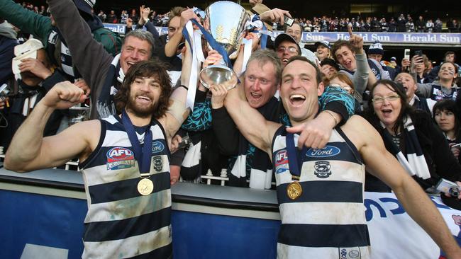2002 rookie draft pick Max Rooke - with Brad Ottens - celebrates Geelong’s 2009 premiership.