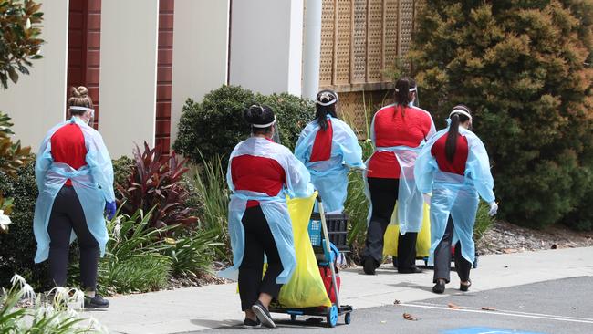 Jeta Gardens staff in protective plastic gowns on Saturday. PHOTO: Annette Dew