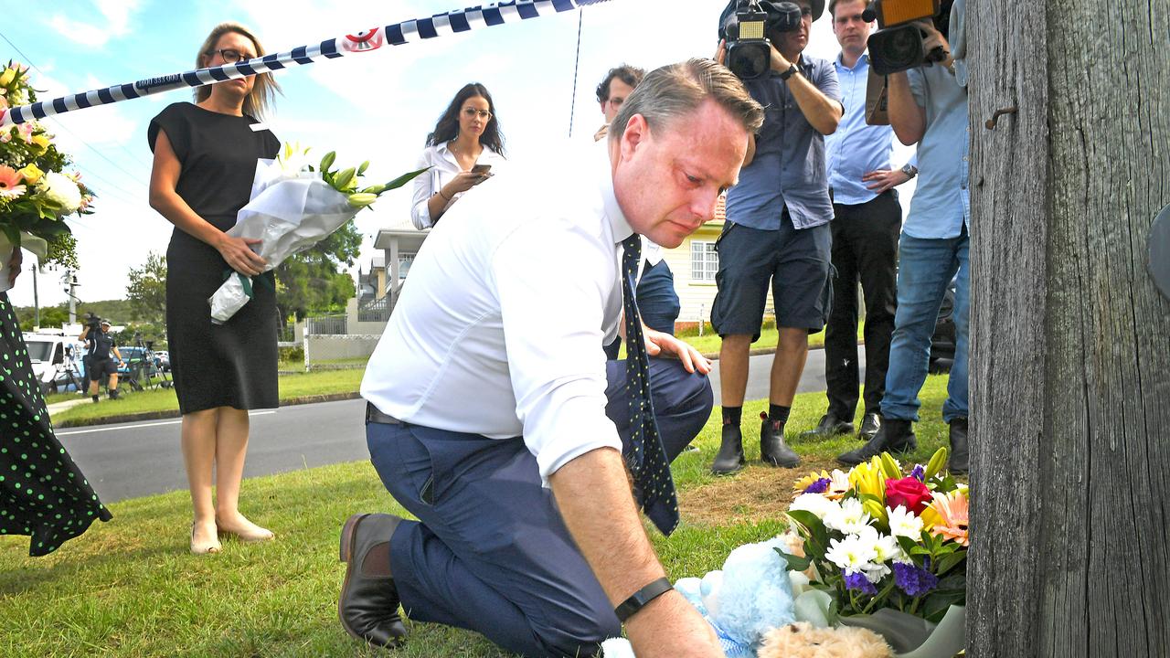 Brisbane Mayor Adrian Schrinner leaves flowers for the children in Camp Hill. Picture: AAP/John Gass