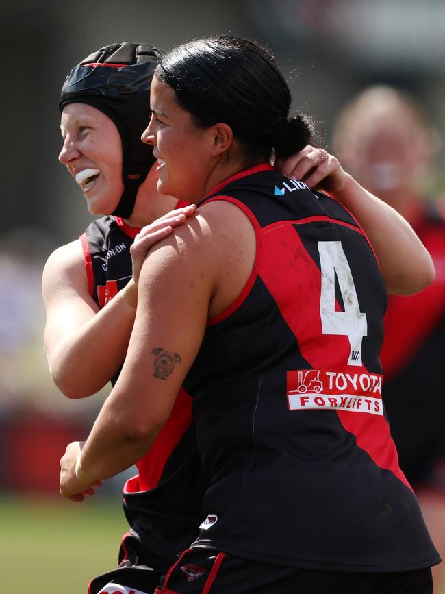 Essendon debutant Chloe Adams (left) is embracing the chance to learn from star Bomber Maddy Prespakis (right). Picture: Will Russell/AFL Photos via Getty Images