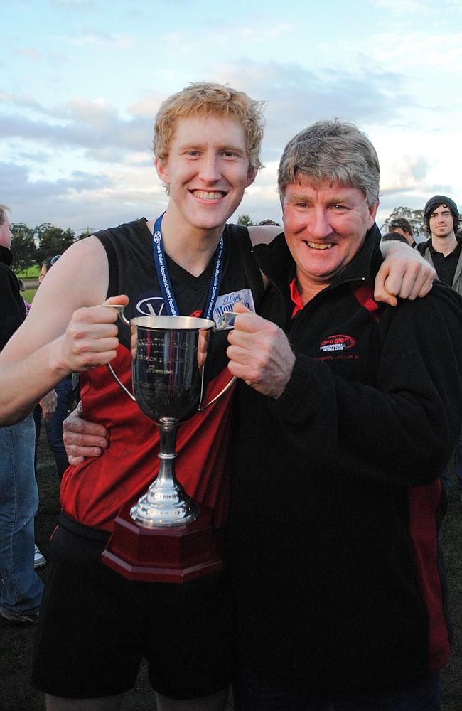 Ball with this Dad David with the premiership cup at the 2010 Division 2 seniors grand final in 2010.