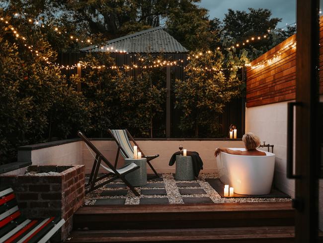 Braithwaite outdoor bath in the garden courtyard under the twinkly fairy lights. For TasWeekend travel story. ONE-TIME USE ONLY for re-use must contact Kirsty Eade. MUST CREDIT Renee Thurston