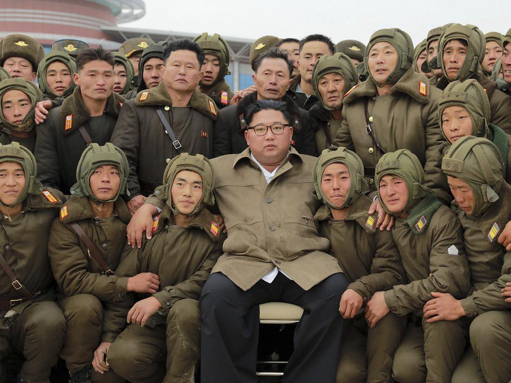 North Korean leader Kim Jong-un poses with air force sharpshooters and soldiers after he supervised a parachuting drill. Picture: Korean Central News Agency/Korea News Service/AP