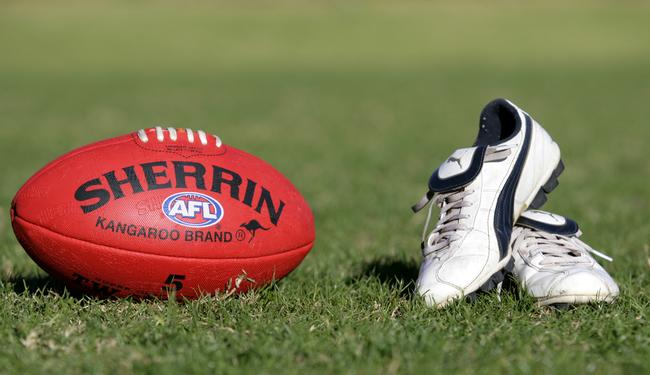 Generic AFL Sherrin football and football boots. sport /