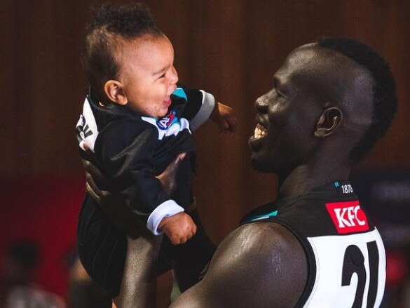 Port Adelaide’s Aliir Aliir with son, Mayom. Picture: Port Adelaide Football Club (Instagram)