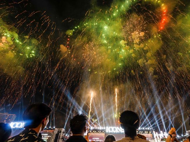 People watch as fireworks light up the sky during New Year's Eve celebrations in Bangkok on January 1, 2024. Picture: AFP