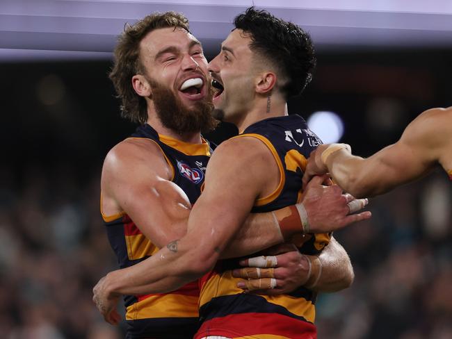 Izak Rankine celebrates one of his two final-quarter goals with Riley Thilthorpe. Picture: James Elsby/AFL Photos