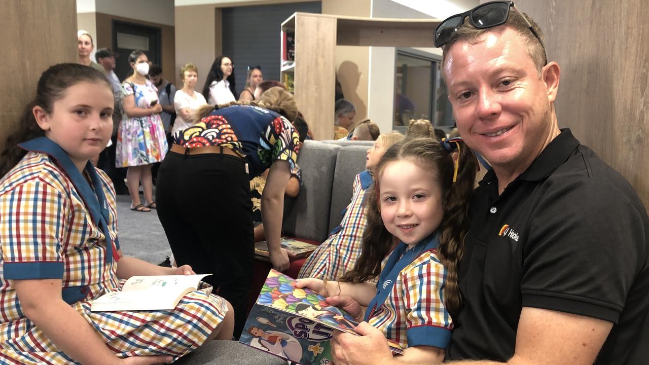 The first day of school in prep at Queensland’s newest primary school Scenic Shores State School for Lucy Jamieson who is reading a book with dad Trent Jamieson. Pictures; JUDITH KERR