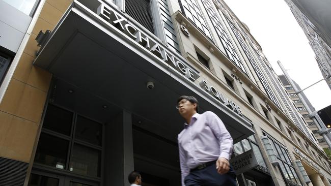 Pedestrians walk past the ASX Ltd. exchange centre in Sydney, Australia, on Thursday, Feb. 14, 2019. “We made good progress on our core initiatives across the period, including the program to replace CHESS with distributed ledger technology; upgrade of our secondary data centre to strengthen market resilience; and restructure of our Listings Compliance team to enhance the quality of market oversight,” ASX Chief Executive Officer Dominic Stevens said. Photographer: David Moir/Bloomberg