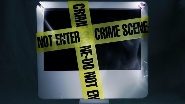 Yellow 'crime scene do not enter' tape wrapped around a computer screen.