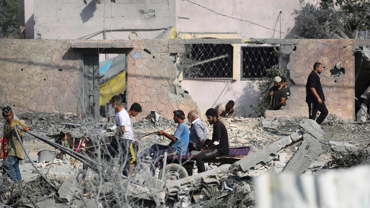 People pass the rubble of buildings hit during Israeli bombardment in Nuseirat, in the central Gaza Strip. Picture: Eyad Baba/AFP