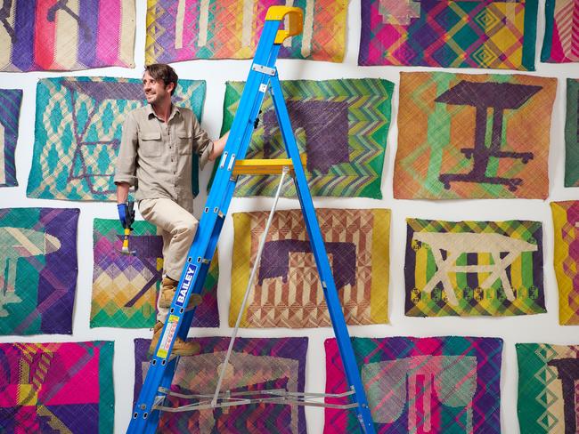 EMBARGO FOR TWAM 16 DEC 2023. FEE MAY APPLY. Art handler Linden Pomare installing Yee I-Lannâs work Tikar/Meja (Mat/Table), 2019-20, in the NGV Triennial, opening 3 December at NGV International, Melbourne. Photo: Eugene Hyland.