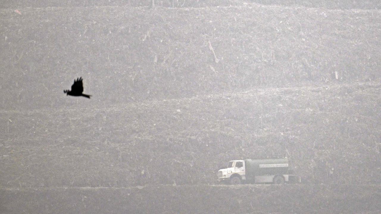 A rubbish truck rides across the Ghazipur landfill amid smoggy conditions in New Delhi. Picture: Arun Sankar/AFP