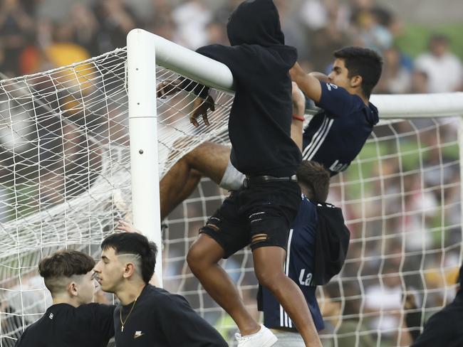 MELBOURNE, AUSTRALIA - DECEMBER 17: Fans storm the pitch in protest during the round eight A-League Men's match between Melbourne City and Melbourne Victory at AAMI Park, on December 17, 2022, in Melbourne, Australia. (Photo by Darrian Traynor/Getty Images)