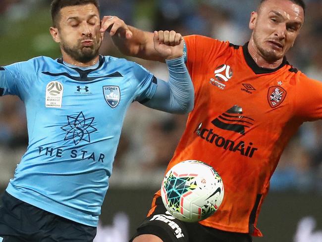 Kosta Barbarouses of Sydney FC and Captain of the Roar Tom Aldred challenge for the ball during the Round 9 A-League match between Sydney FC and Brisbane Roar at Netstrata Jubilee Stadium in Sydney, Saturday, December 7, 2019. (AAP Image/Jeremy Ng) NO ARCHIVING, EDITORIAL USE ONLY