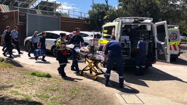 A man is taken to an ambulance outside the Andrew Charlton Aquatic Centre in Manly in October last year. Picture: Julie Cross