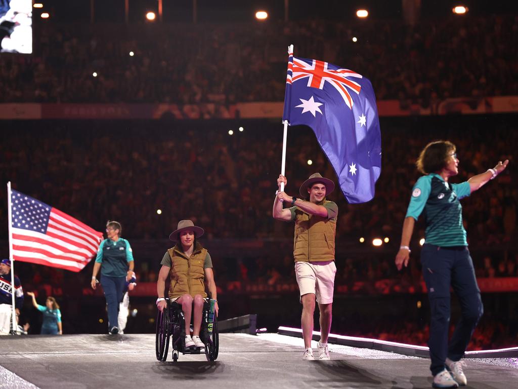 Flag bearers for Team Australia, Lauren Parker and James Turner join the parade during the closing ceremony. Picture: Steph Chambers/Getty Images