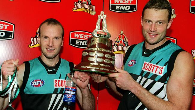 Josh Francou with the Showdown Medal and Matthew Primus the trophy after Port Adelaide’s victory in Showdown 10 in 2001. 