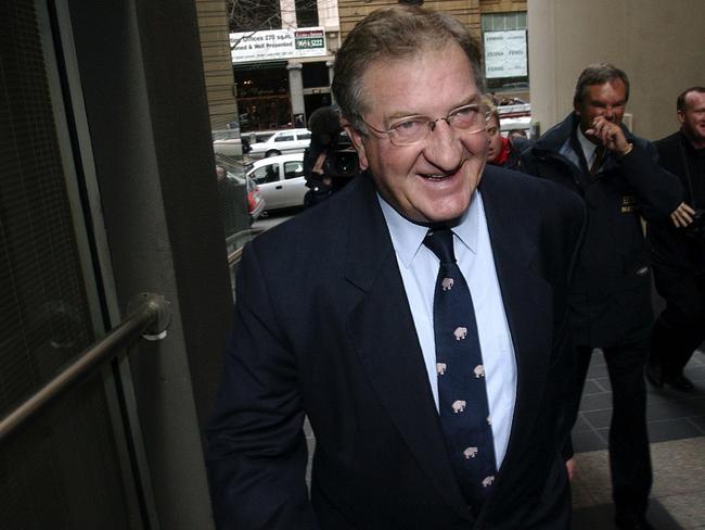 Melbourne, June 30, 2003. Businessman John Elliott smiling after he crossed Collins Street in Melbourne today after a Supreme Court judge ordered he pay over $1.4 million in compensation for allowing his company to trade while insolvent. (AAP Image/Julian Smith) NO ARCHIVING