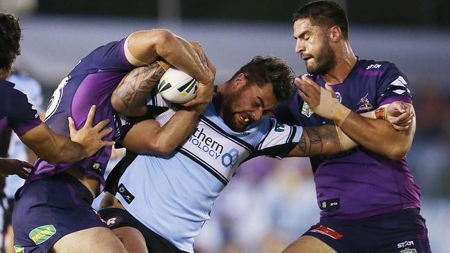 Andrew Fifita is swarmed by Storm defenders.