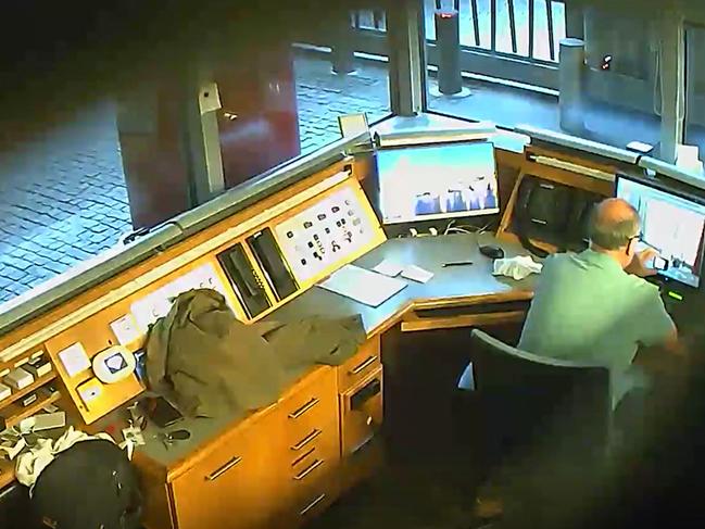 A covert camera shows Russian spy David Smith taking video of CCTV monitors in the British Embassy security kiosk in Berlin. Picture: AFP