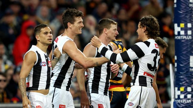 Collingwood players celebrate a goal against the Crows last week. Picture: Sarah Reed/AFL Photos via Getty Images