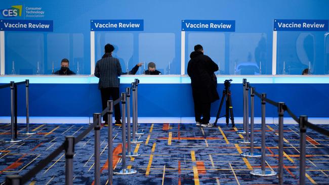 Attendees have their Covid-19 vaccination cards reviewed before receiving their badges ahead of CES. Picture: AFP