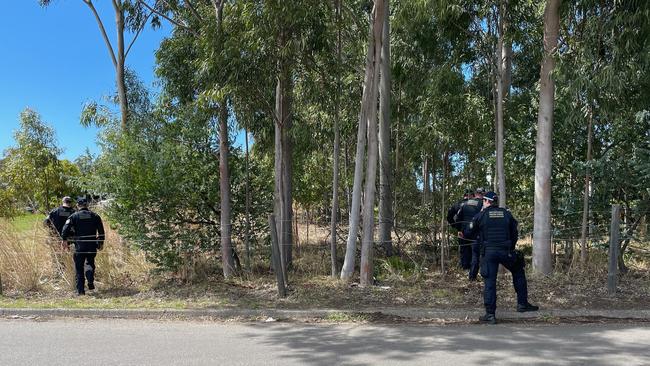 Police search bushland and set up a crime scene after a shot was fired at a car in Mt Hutton. Picture: Amy Ziniak