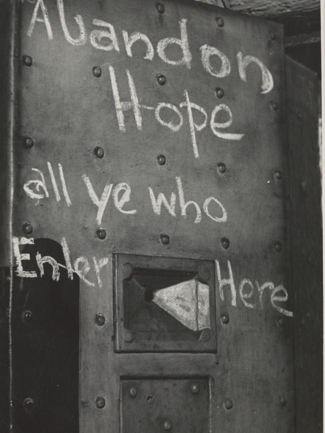 Writing on a cell door at Melbourne Gaol in 1937. Picture: State Library Victoria.