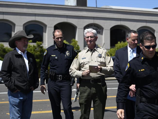 San Diego County Sheriff Bill Gore, centre, arrives with other law enforcement officials at the  Chabad of Poway Synagogue. 