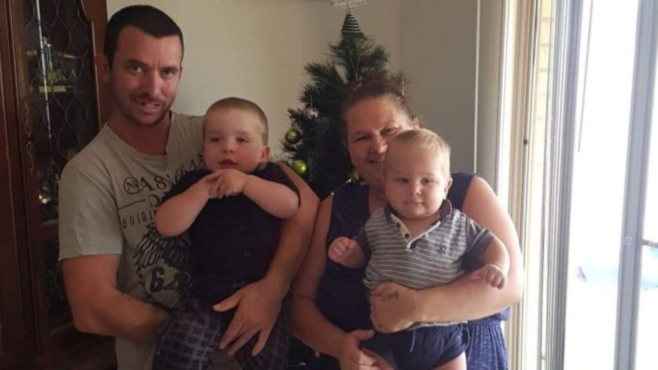 One punch victim Darren Adcock with his partner and children.