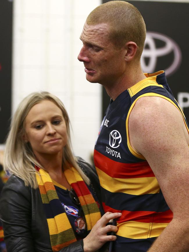 A distraught Sam Jacobs, who was on of the Crows’ best, with his wife Izzy after the match. Picture: Sarah Reed