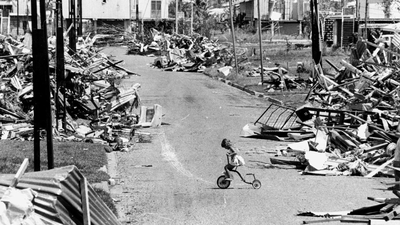 28 Dec 1974 Little girl, Poppy Magoulis (now Papazoglou) riding her bicycle on the street which was destroyed by Cyclone Tracy in Darwin 25 Dec. PicBruce/Howard weather nt storms damage wreckage